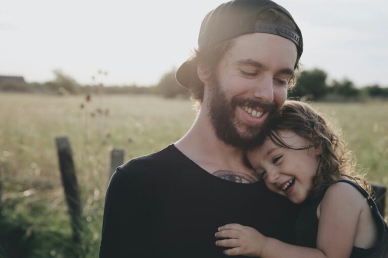 man holding child - both smiling